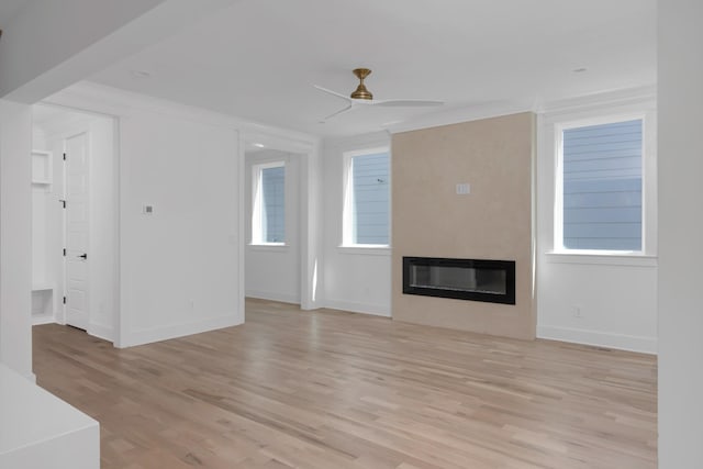 6401 Thunderbird Dr, Nashville, TN 37209 - unfurnished living room with a large fireplace, a ceiling fan, light wood-style floors, baseboards, and ornamental molding