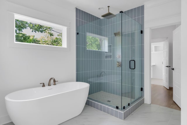 6401 Thunderbird Dr, Nashville, TN 37209 - bathroom featuring marble look tile flooring, a shower stall, and a soaking tub