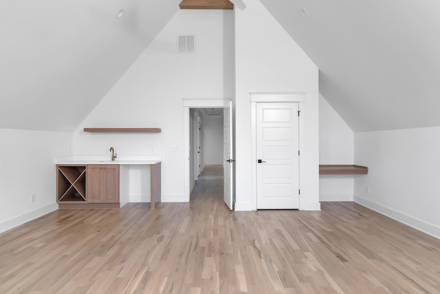 6401 Thunderbird Dr, Nashville, TN 37209 - additional living space featuring vaulted ceiling, light wood-type flooring, baseboards, and a sink