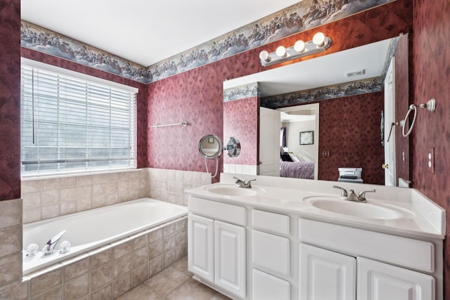 bathroom with wallpapered walls, double vanity, a garden tub, ensuite bath, and tile patterned floors