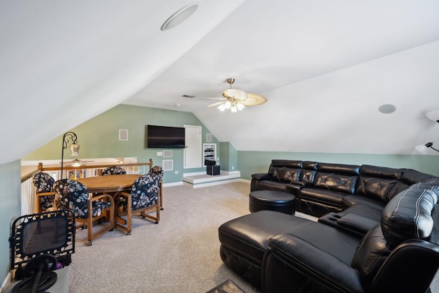 carpeted living room with a ceiling fan, vaulted ceiling, and baseboards