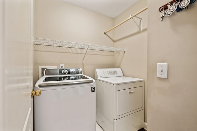 laundry room with independent washer and dryer