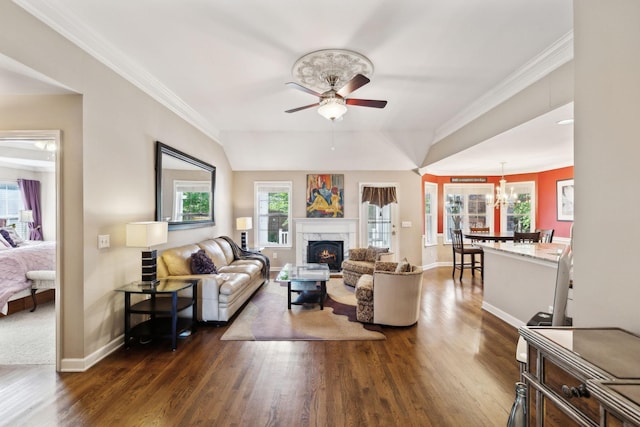 living area with a ceiling fan, dark wood-style flooring, a fireplace, baseboards, and plenty of natural light