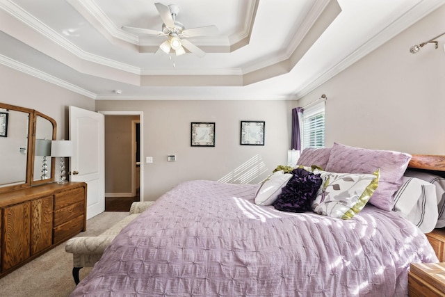 bedroom featuring a raised ceiling, crown molding, a ceiling fan, and light carpet