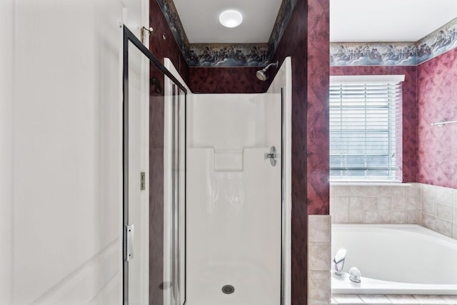 full bath featuring a stall shower, a garden tub, and wallpapered walls