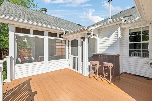wooden deck featuring a sunroom