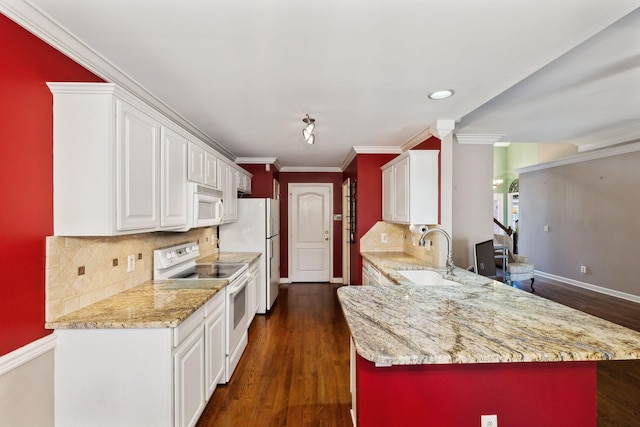 kitchen with a sink, white appliances, white cabinetry, a peninsula, and light stone countertops