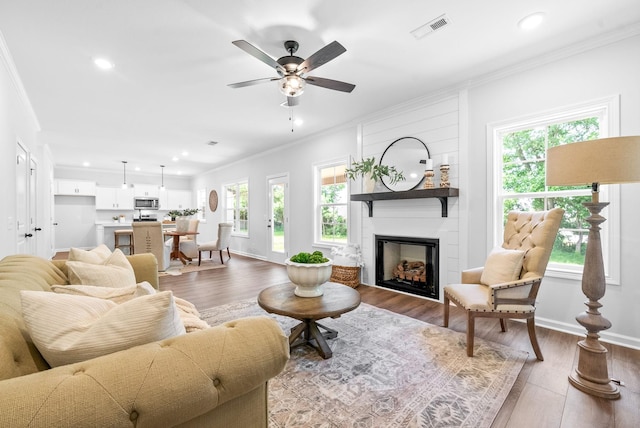 272 Kildeer Dr, Clarksville, TN 37040 - living room with crown molding, wood finished floors, a large fireplace, a ceiling fan, and recessed lighting