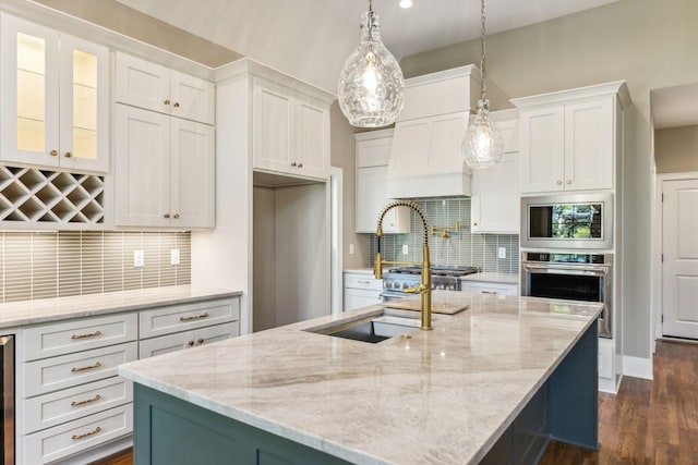 1611 Martha Washington Way, Murfreesboro, TN 37130 - kitchen featuring appliances with stainless steel finishes, white cabinets, decorative backsplash, and a center island with sink