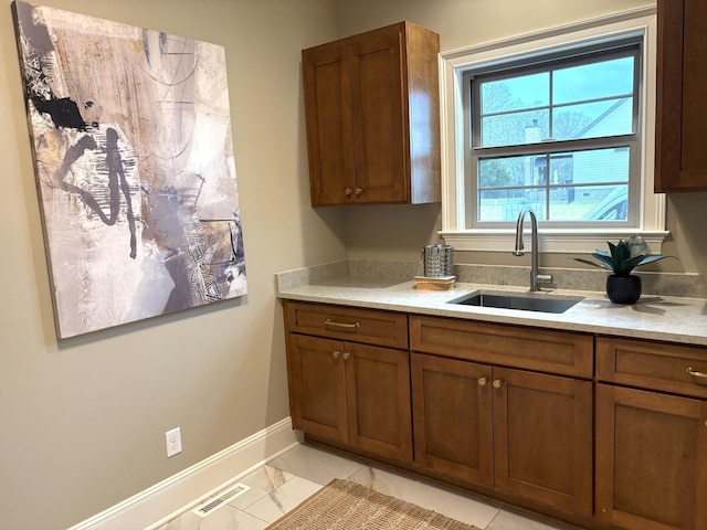 1611 Martha Washington Way, Murfreesboro, TN 37130 - kitchen with a sink, baseboards, brown cabinetry, and light countertops