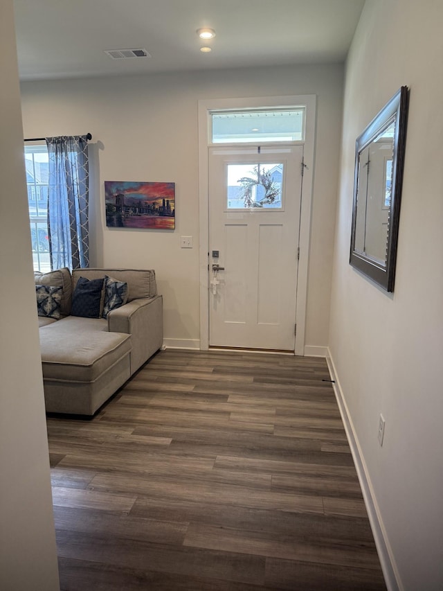 foyer entrance featuring plenty of natural light, baseboards, dark wood finished floors, and recessed lighting