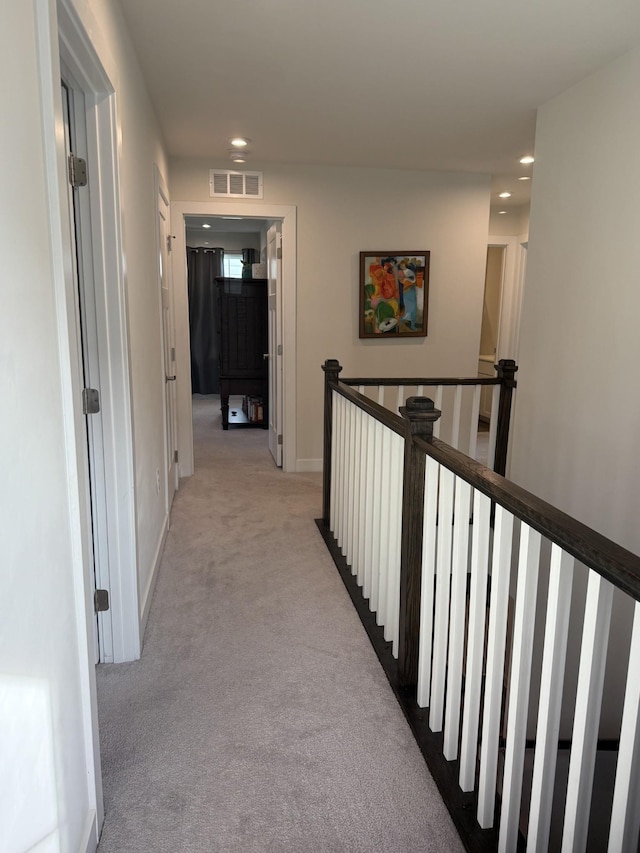 hallway with carpet, recessed lighting, an upstairs landing, and baseboards