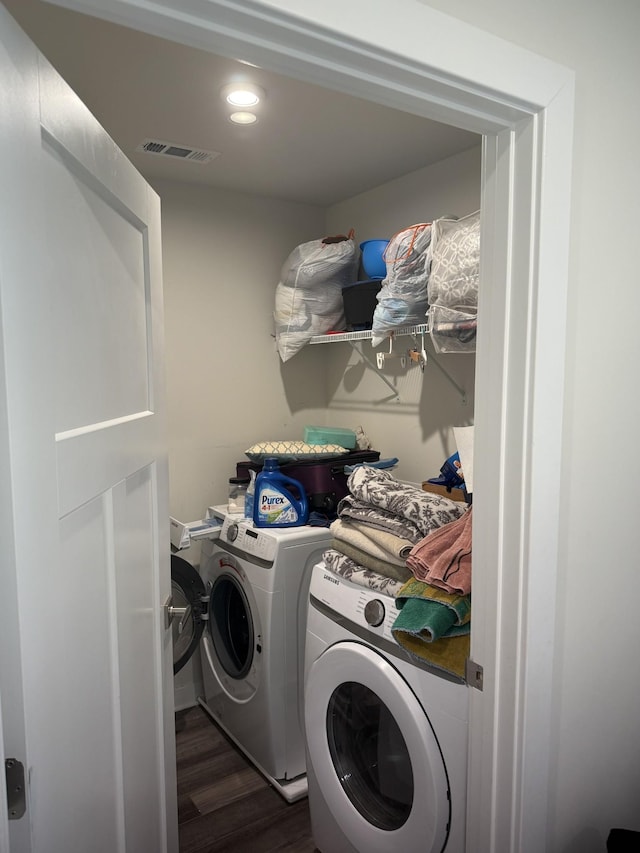laundry area with washer and dryer, dark wood-type flooring, and recessed lighting