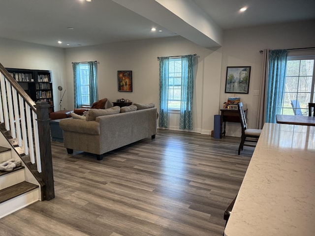 living area featuring stairs, dark wood-type flooring, recessed lighting, and baseboards