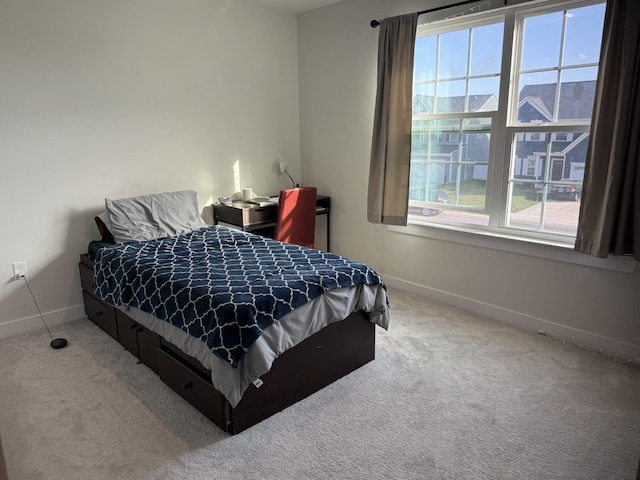 carpeted bedroom with baseboards