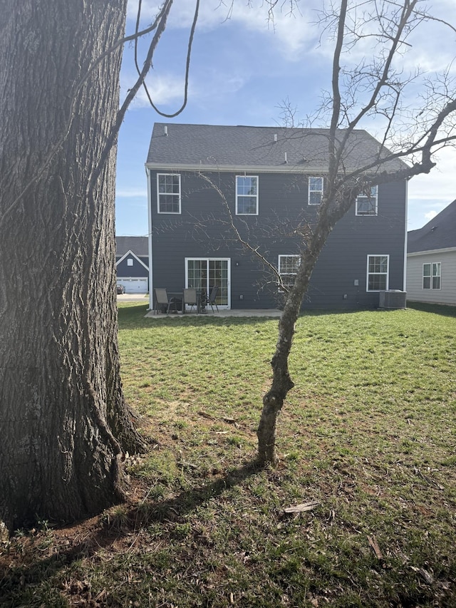 back of property featuring a lawn, a patio, and central AC