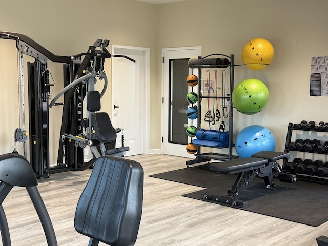 exercise area featuring wood finished floors and baseboards