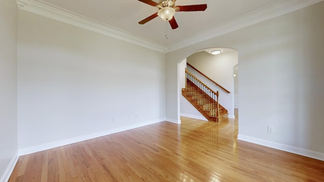 4050 Oak Pointe Dr, Pleasant View, TN 37146 - spare room with arched walkways, a ceiling fan, stairway, light wood-type flooring, and ornamental molding