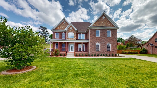 4050 Oak Pointe Dr, Pleasant View, TN 37146 - view of front of house with brick siding, a porch, and a front lawn
