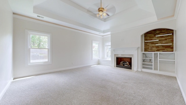 4050 Oak Pointe Dr, Pleasant View, TN 37146 - unfurnished living room featuring a tray ceiling, carpet flooring, ceiling fan, a fireplace, and baseboards