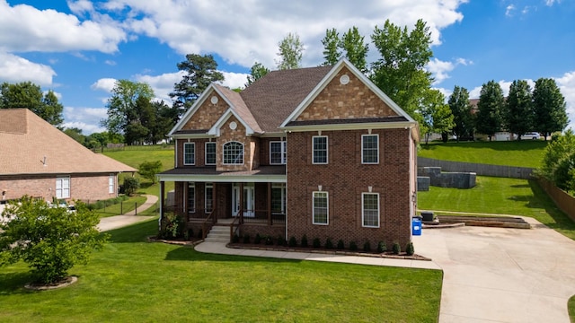 4050 Oak Pointe Dr, Pleasant View, TN 37146 - view of front of property featuring a porch, brick siding, and a front lawn