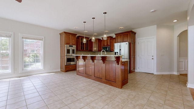 4050 Oak Pointe Dr, Pleasant View, TN 37146 - kitchen with appliances with stainless steel finishes, arched walkways, light tile patterned floors, backsplash, and recessed lighting