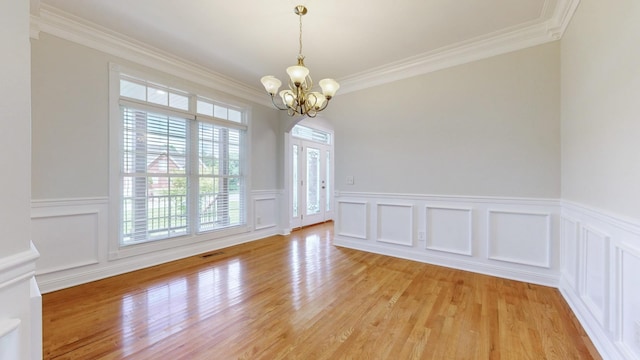 4050 Oak Pointe Dr, Pleasant View, TN 37146 - unfurnished dining area featuring a chandelier, crown molding, light wood finished floors, a decorative wall, and a wainscoted wall