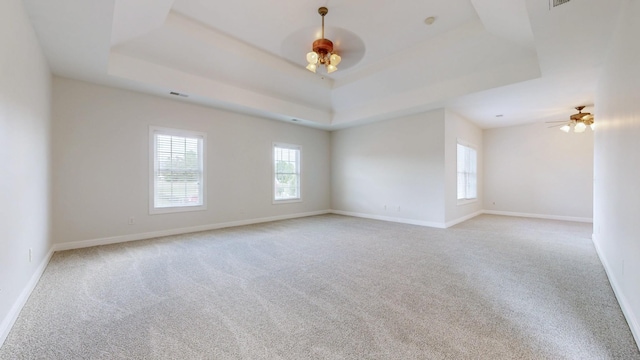 4050 Oak Pointe Dr, Pleasant View, TN 37146 - carpeted spare room featuring a ceiling fan, a tray ceiling, and baseboards