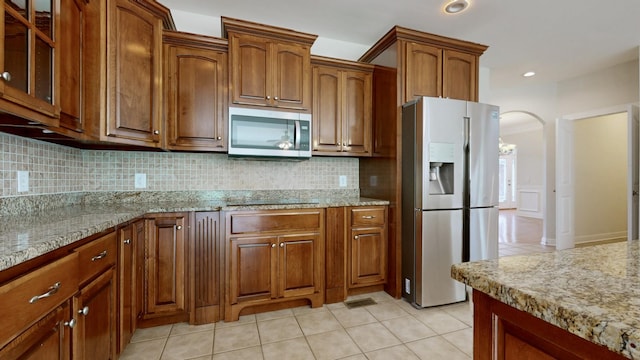 4050 Oak Pointe Dr, Pleasant View, TN 37146 - kitchen featuring appliances with stainless steel finishes, decorative backsplash, light tile patterned floors, light stone counters, and recessed lighting