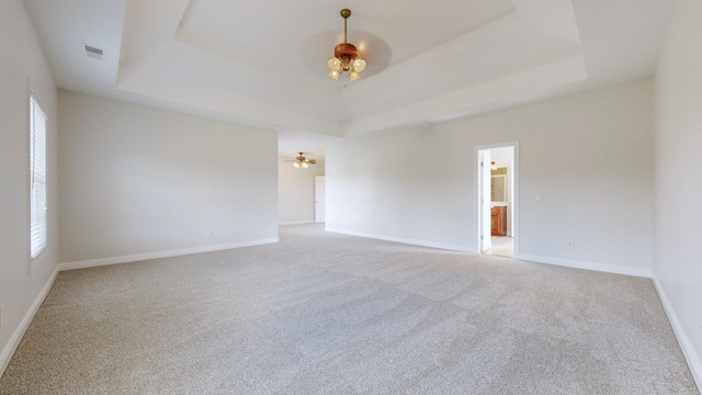 4050 Oak Pointe Dr, Pleasant View, TN 37146 - carpeted spare room featuring a tray ceiling, baseboards, a ceiling fan, and plenty of natural light