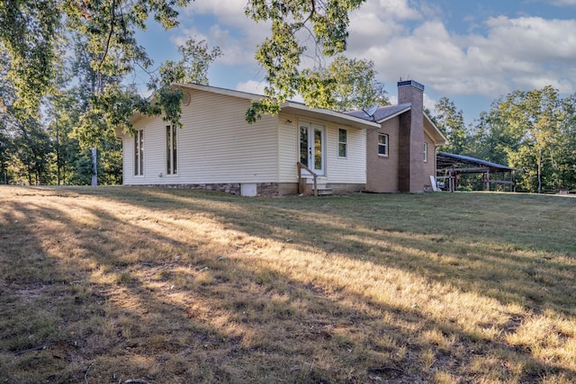 960 Knob Creek Rd, Lawrenceburg, TN 38464 - back of property with a chimney, a lawn, entry steps, and a carport