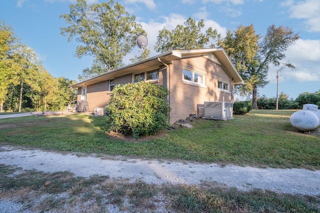 960 Knob Creek Rd, Lawrenceburg, TN 38464 - view of side of home featuring a lawn, brick siding, and cooling unit