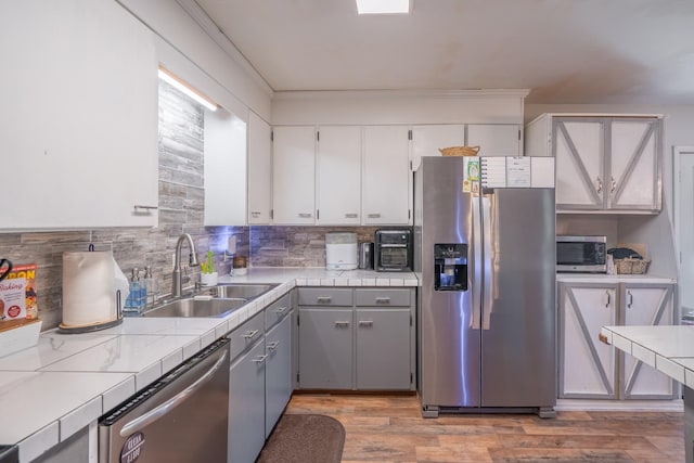 960 Knob Creek Rd, Lawrenceburg, TN 38464 - kitchen with stainless steel appliances, a sink, tile countertops, and backsplash