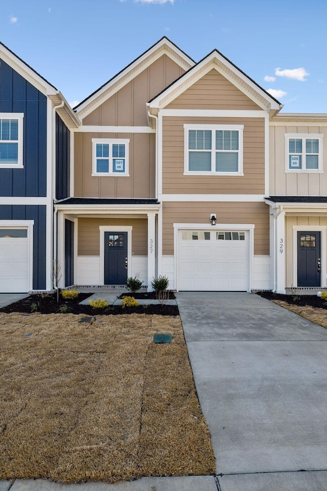 view of property featuring concrete driveway, an attached garage, and board and batten siding