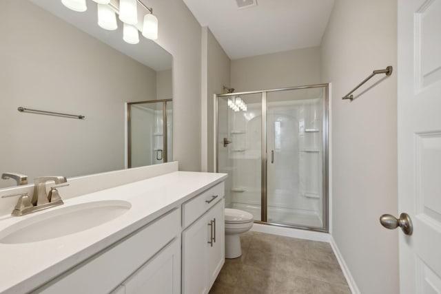 full bathroom featuring a shower stall, toilet, vanity, tile patterned floors, and baseboards