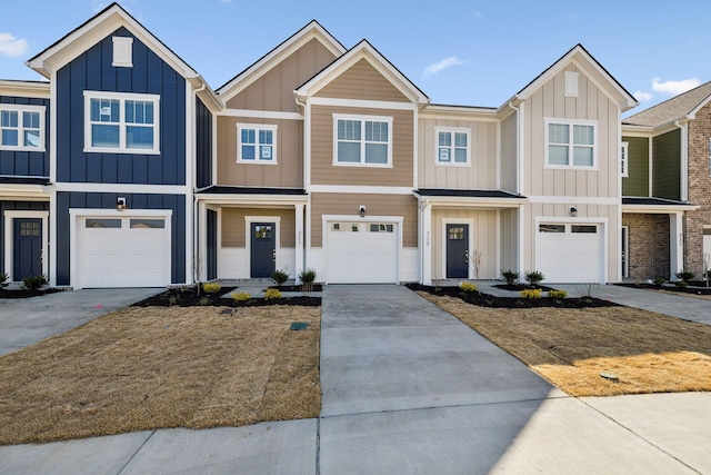 multi unit property with board and batten siding, driveway, and an attached garage