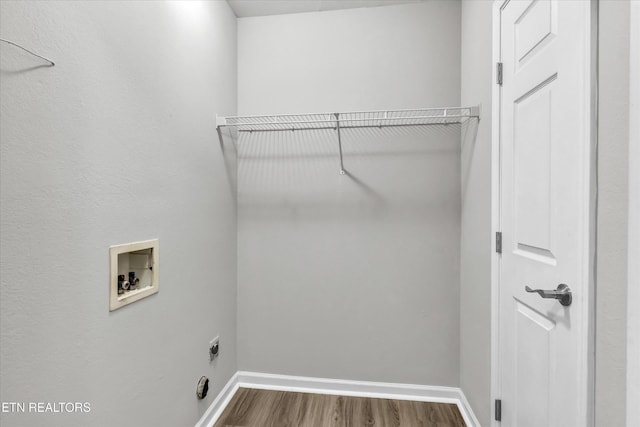 laundry room with hookup for a washing machine, dark wood finished floors, baseboards, and hookup for an electric dryer