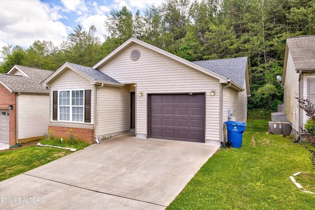 ranch-style home with a garage, driveway, a front yard, and a shingled roof