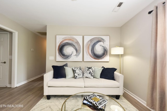 living area featuring wood finished floors and baseboards
