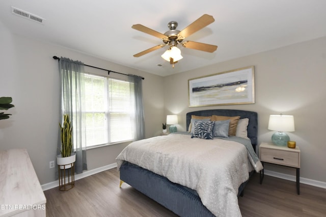 bedroom with baseboards, wood finished floors, and a ceiling fan