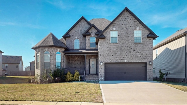 1408 Kingbird Dr, Clarksville, TN 37040 - view of front of house with brick siding, an attached garage, a front yard, and driveway