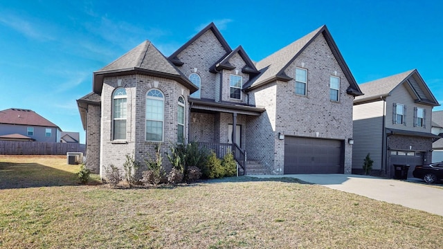 1408 Kingbird Dr, Clarksville, TN 37040 - french provincial home featuring brick siding, an attached garage, concrete driveway, and central AC