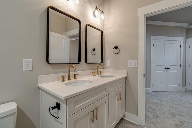 1022 Gadwall Ln, Spring Hill, TN 37174 - bathroom featuring double vanity, toilet, and baseboards