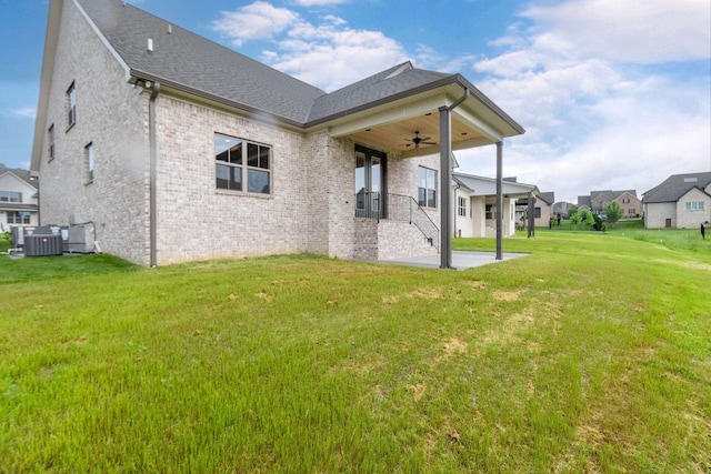 1022 Gadwall Ln, Spring Hill, TN 37174 - rear view of property with a ceiling fan, a yard, brick siding, central AC unit, and a shingled roof