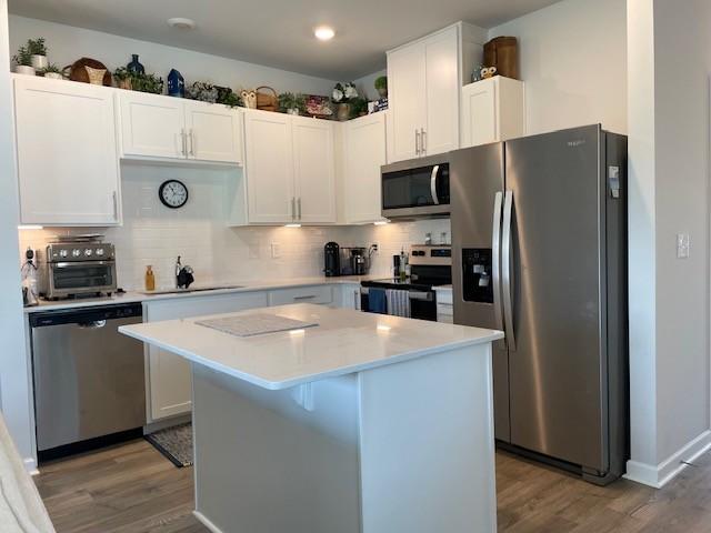 1401 Walker Way, Columbia, TN 38401 - kitchen with stainless steel appliances, a sink, wood finished floors, light countertops, and recessed lighting