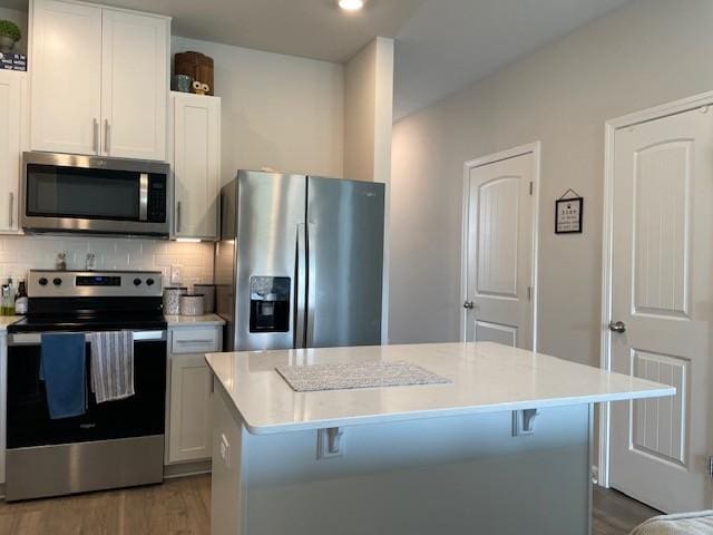 1401 Walker Way, Columbia, TN 38401 - kitchen featuring stainless steel appliances, wood finished floors, light countertops, and backsplash