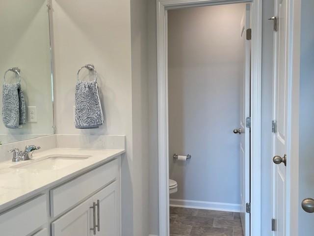 1401 Walker Way, Columbia, TN 38401 - bathroom with vanity, toilet, baseboards, and stone finish flooring