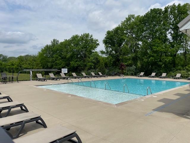 1401 Walker Way, Columbia, TN 38401 - community pool with a patio, fence, and view of wooded area