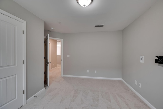 unfurnished room featuring baseboards and carpet floors