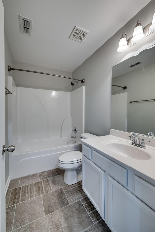 bathroom featuring toilet,  shower combination, and vanity